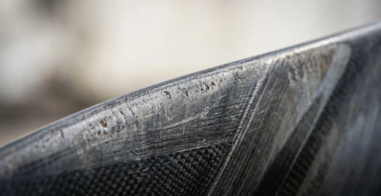 Gros plan macro sur les pales d'une éolienne domestique montrant les détails de fabrication et les contraintes mécaniques
